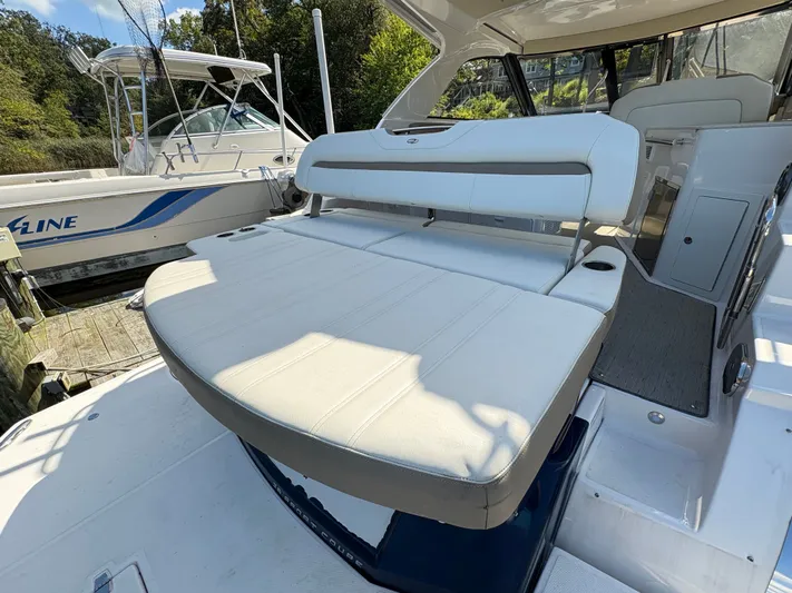 Wining Down Yacht Photos Pics 2016 Regal 35 Sport Coupe boat with spacious white seating area.