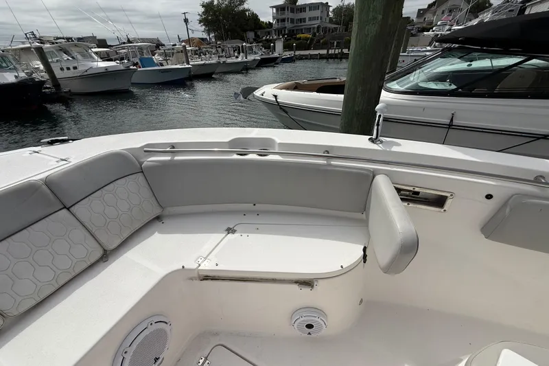  Yacht Photos Pics 2021 Sea Fox 288 Commander boat interior with cushioned seating at a marina.
