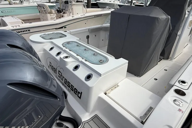  Yacht Photos Pics 2021 Sea Fox 288 Commander boat interior with fishing equipment and covered seating.