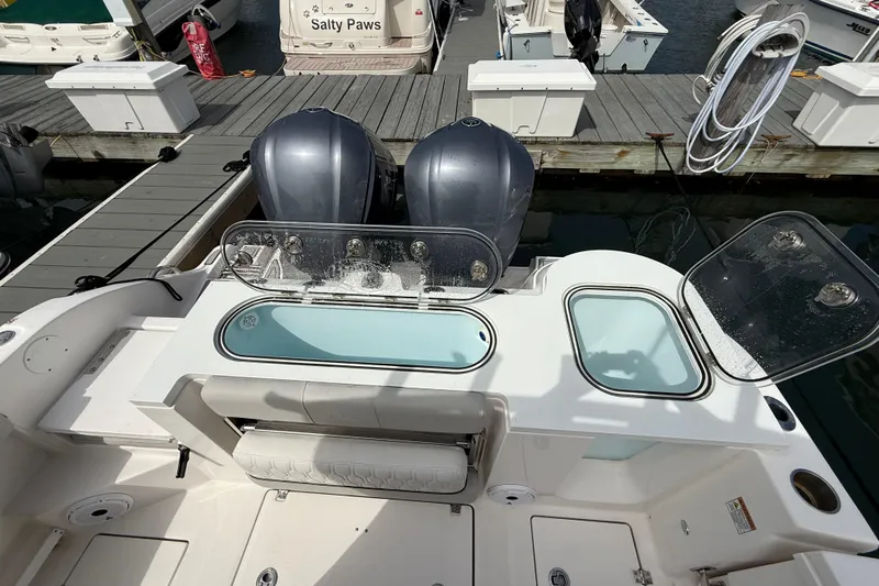  Yacht Photos Pics 2021 Sea Fox 288 Commander boat with dual engines and open storage compartments at dock.