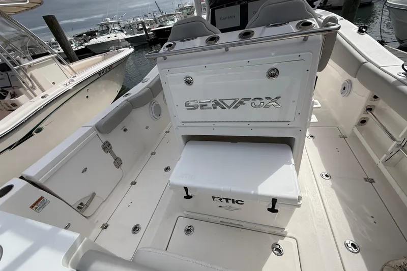  Yacht Photos Pics 2021 Sea Fox 288 Commander boat interior with seating and storage, docked at marina.