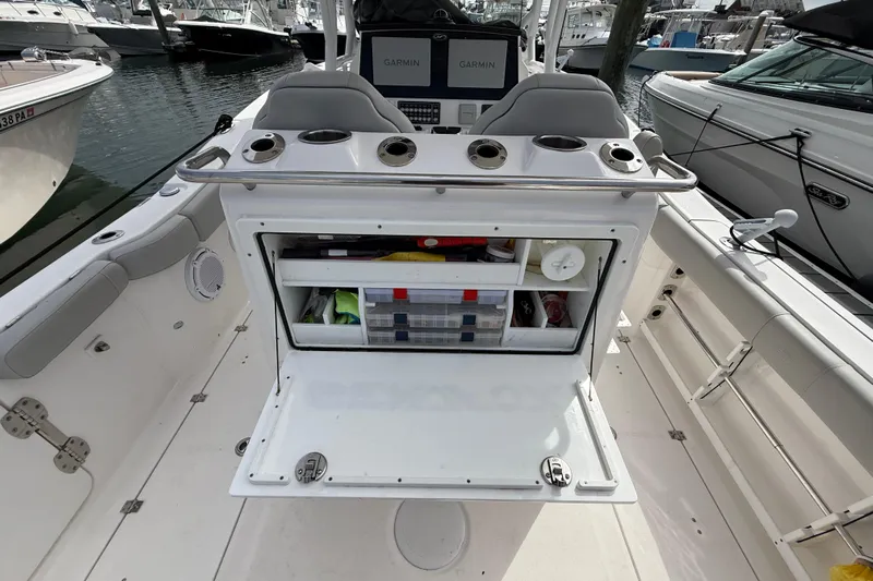  Yacht Photos Pics 2021 Sea Fox 288 Commander boat interior with open storage compartment and Garmin displays.