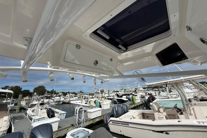 Yacht Photos Pics 2021 Sea Fox 288 Commander at marina, showcasing overhead storage and rod holders.