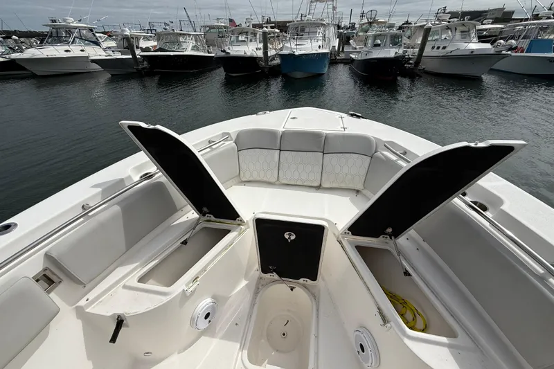  Yacht Photos Pics 2021 Sea Fox 288 Commander boat with open storage compartments, docked among other boats.
