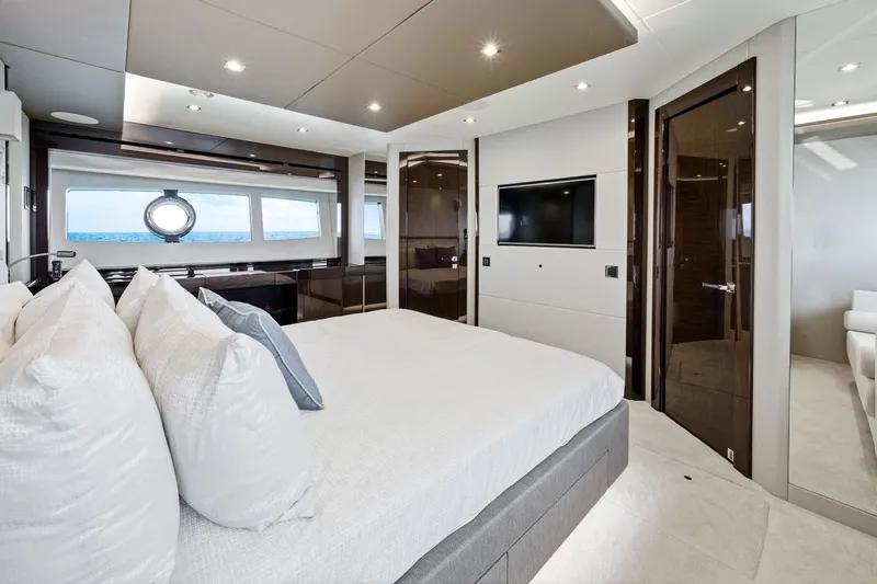 Pura Vida Yacht Photos Pics Luxurious 2022 Sunseeker Motoryacht bedroom with ocean view and modern amenities.