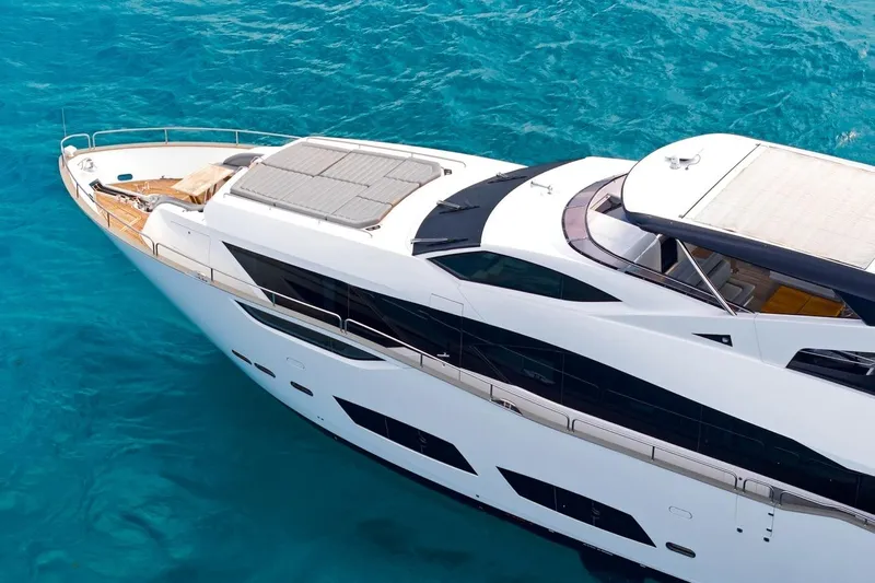 Pura Vida Yacht Photos Pics Luxurious 2022 Sunseeker Motoryacht on clear blue water, showcasing sleek design and elegance.
