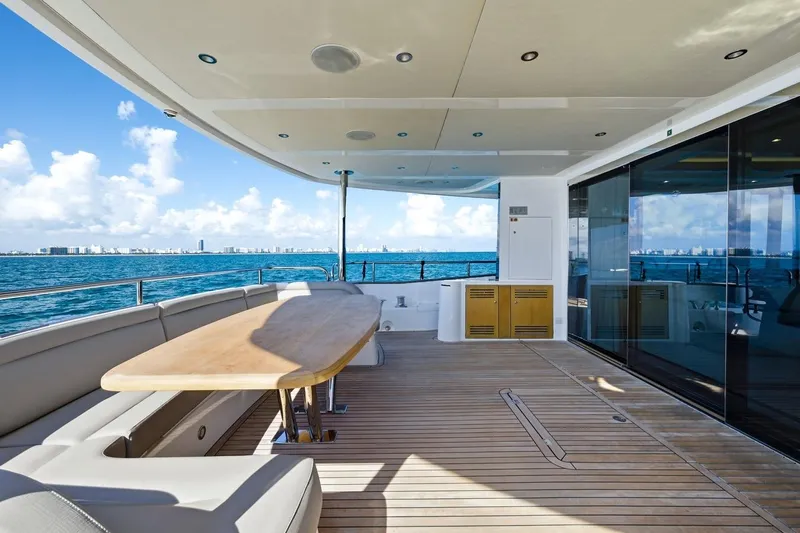Pura Vida Yacht Photos Pics Luxurious 2022 Sunseeker Motoryacht deck with ocean view and elegant seating area.