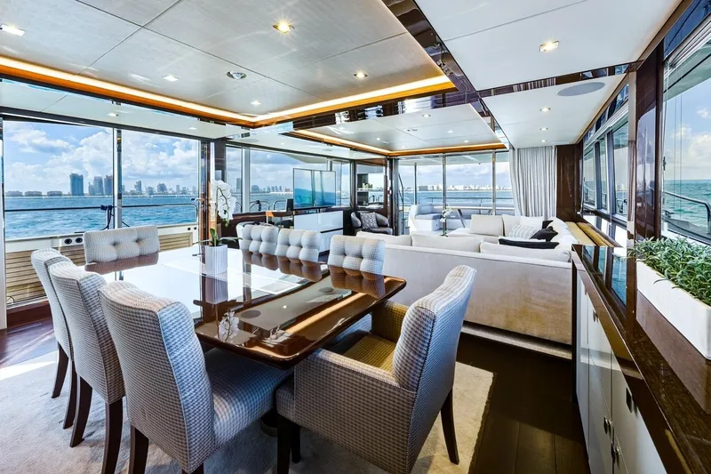 Pura Vida Yacht Photos Pics Luxurious 2022 Sunseeker Motoryacht interior with elegant dining and lounge area, ocean view.