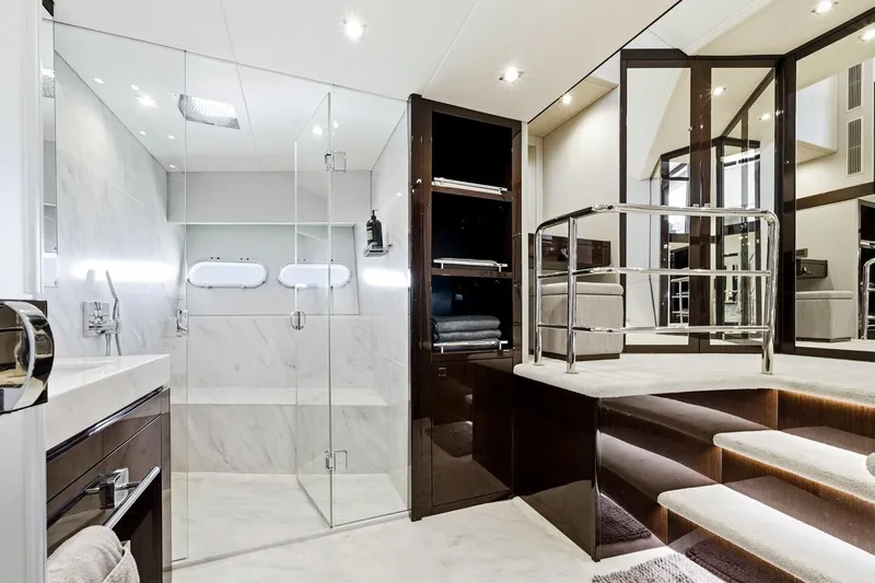 Pura Vida Yacht Photos Pics Luxurious bathroom in 2022 Sunseeker Motoryacht with glass shower and elegant design.