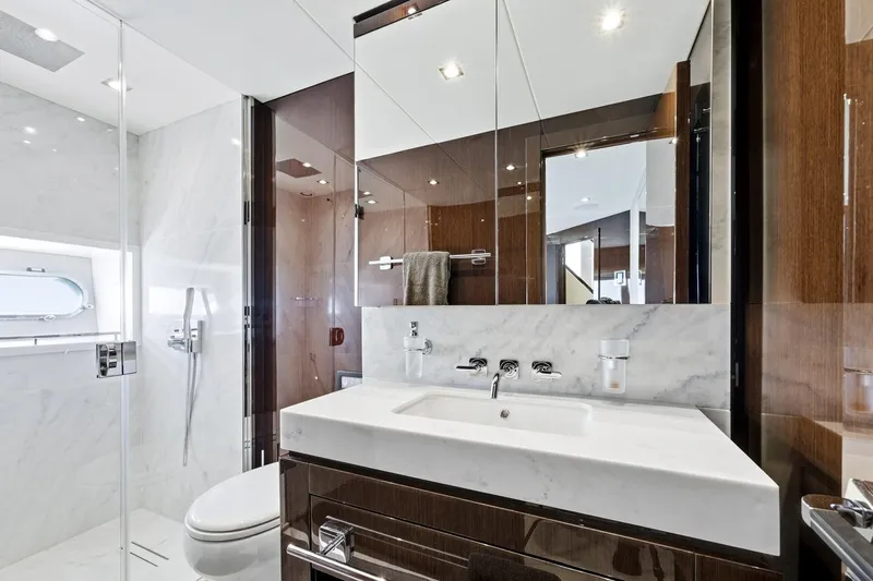 Pura Vida Yacht Photos Pics Luxurious bathroom in 2022 Sunseeker Motoryacht with modern fixtures and elegant design.