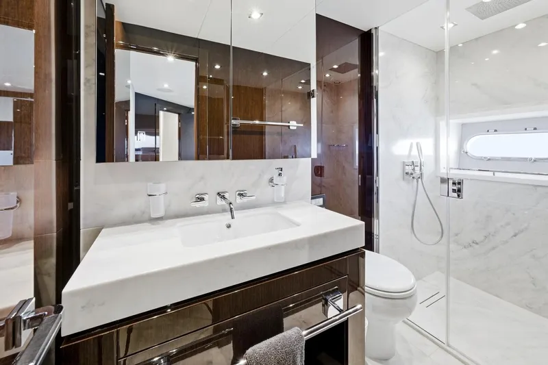 Pura Vida Yacht Photos Pics Luxurious bathroom in 2022 Sunseeker Motoryacht with modern fixtures and elegant design.