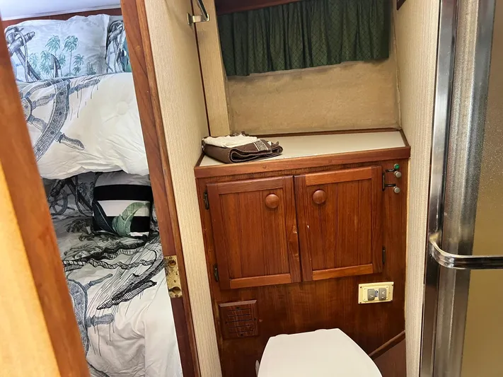 Arvo Arrow Yacht Photos Pics 1985 Chris-Craft 460 Constellation interior with wooden cabinetry and cozy sleeping area.