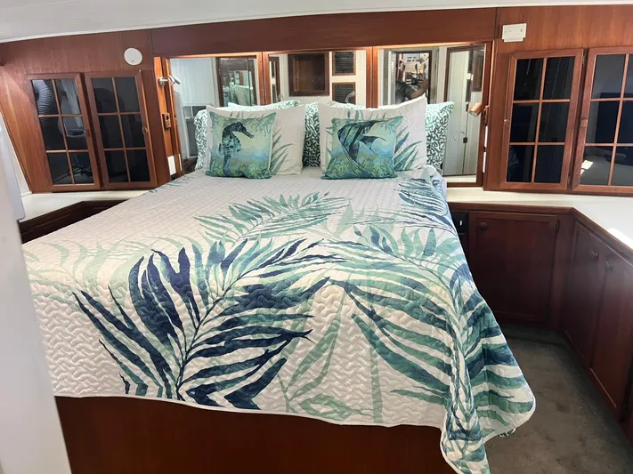 Arvo Arrow Yacht Photos Pics Luxurious bedroom interior of 1985 Chris-Craft 460 Constellation yacht with tropical-themed bedding.