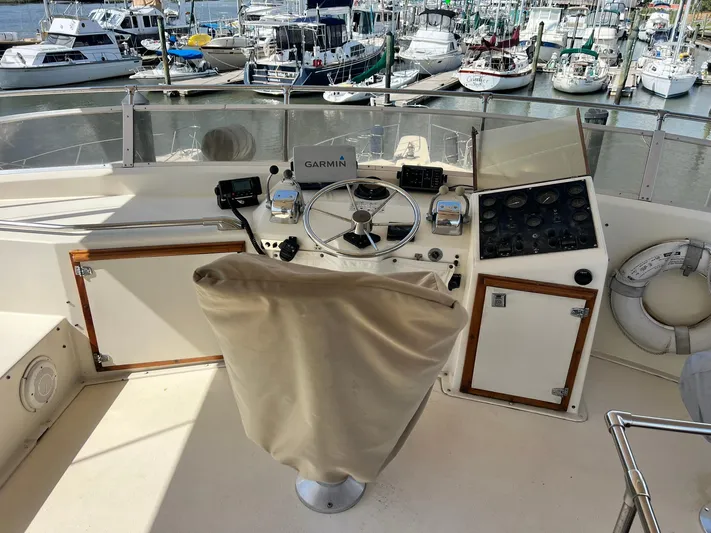 Arvo Arrow Yacht Photos Pics 1985 Chris-Craft 460 Constellation helm with Garmin navigation, docked at a marina.