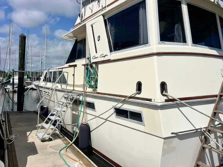 Arvo Arrow Yacht Photos Pics 1985 Chris-Craft 460 Constellation yacht docked at marina under blue sky.