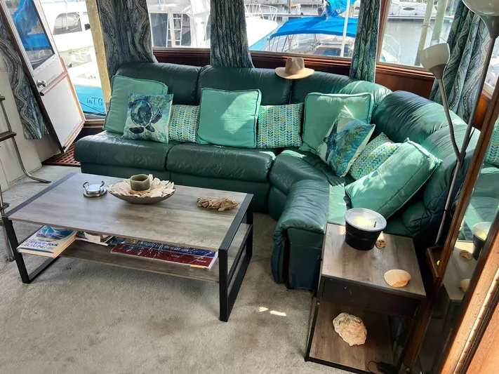 Arvo Arrow Yacht Photos Pics Luxurious interior of 1985 Chris-Craft 460 Constellation yacht with green sofa and nautical decor.