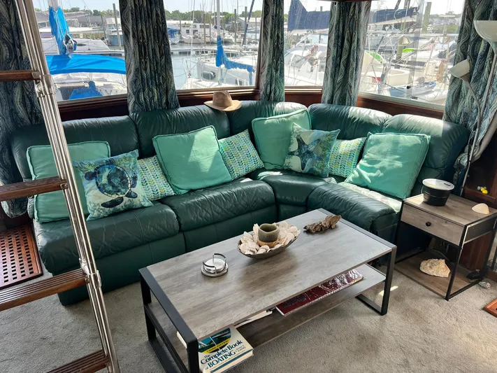 Arvo Arrow Yacht Photos Pics Luxurious 1985 Chris-Craft 460 Constellation yacht interior with green leather seating and nautical decor.