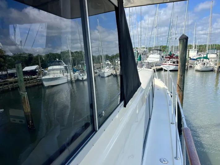 Arvo Arrow Yacht Photos Pics 1985 Chris-Craft 460 Constellation yacht docked at marina with sailboats in background.