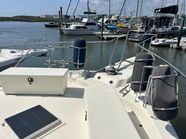 Arvo Arrow Yacht Photos Pics 1985 Chris-Craft 460 Constellation yacht docked in a marina, surrounded by other boats.
