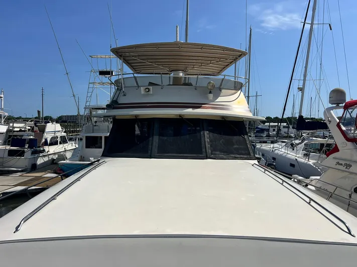 Arvo Arrow Yacht Photos Pics 1985 Chris-Craft 460 Constellation yacht docked at marina, sunny day, clear sky.