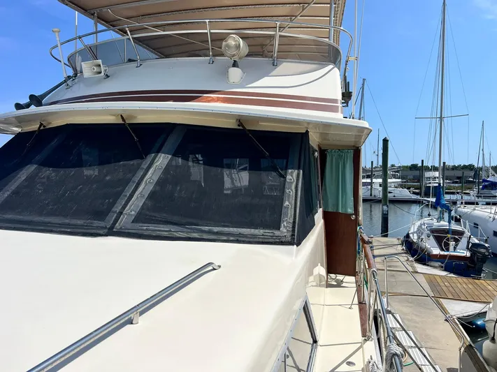 Arvo Arrow Yacht Photos Pics 1985 Chris-Craft 460 Constellation yacht docked at marina under clear blue sky.