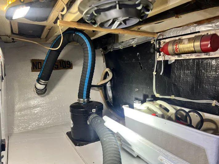 Arvo Arrow Yacht Photos Pics Engine room of 1985 Chris-Craft 460 Constellation with hoses and fire extinguisher.