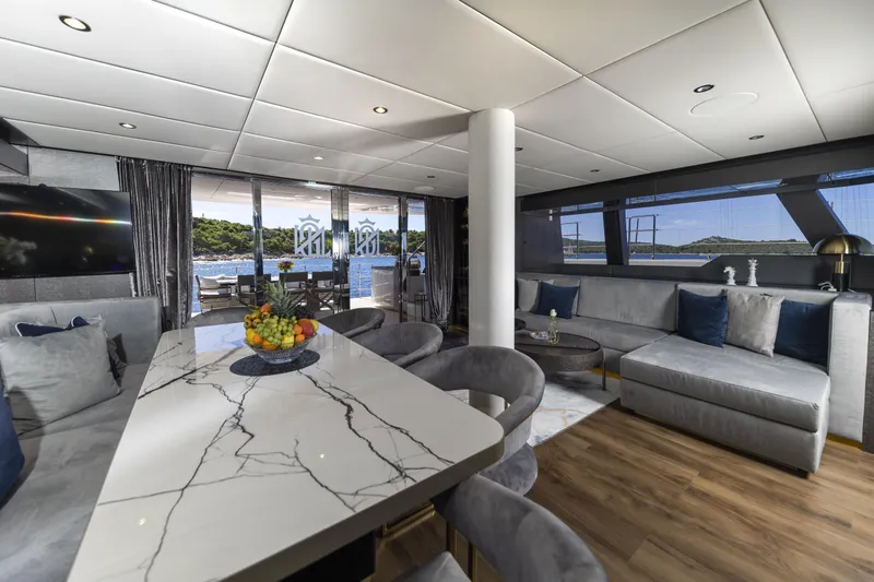 Mr.si Yacht Photos Pics Luxurious interior of 2023 Sunreef 60 Sailing yacht with elegant seating and marble table.