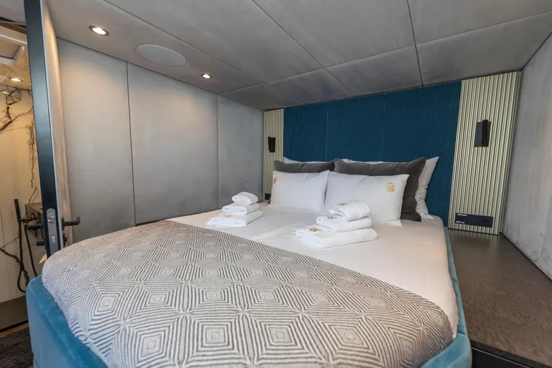 Mr.si Yacht Photos Pics Luxurious bedroom interior on 2023 Sunreef 60 Sailing yacht with elegant bedding and ambient lighting.