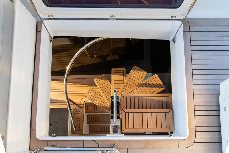 Mr.si Yacht Photos Pics Spiral staircase on 2023 Sunreef 60 Sailing yacht, featuring elegant wooden design.