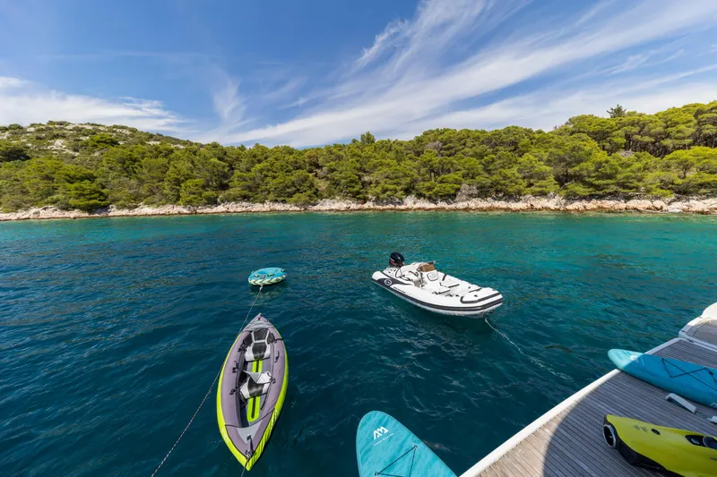 Mr.si Yacht Photos Pics Sunreef 60 Sailing yacht with kayaks and jet ski in a serene coastal setting, 2023.