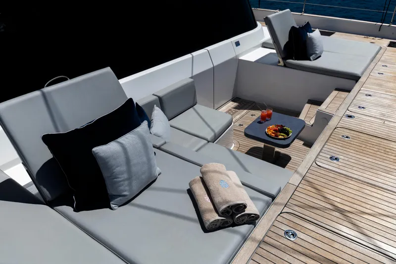 Mr.si Yacht Photos Pics Luxurious Sunreef 60 Sailing yacht deck with plush seating, towels, and refreshments, 2023 model.