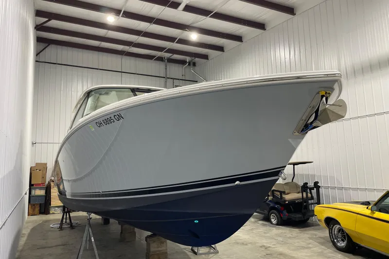  Yacht Photos Pics 2024 Pursuit DC 326 Dual Console boat in storage, side view.