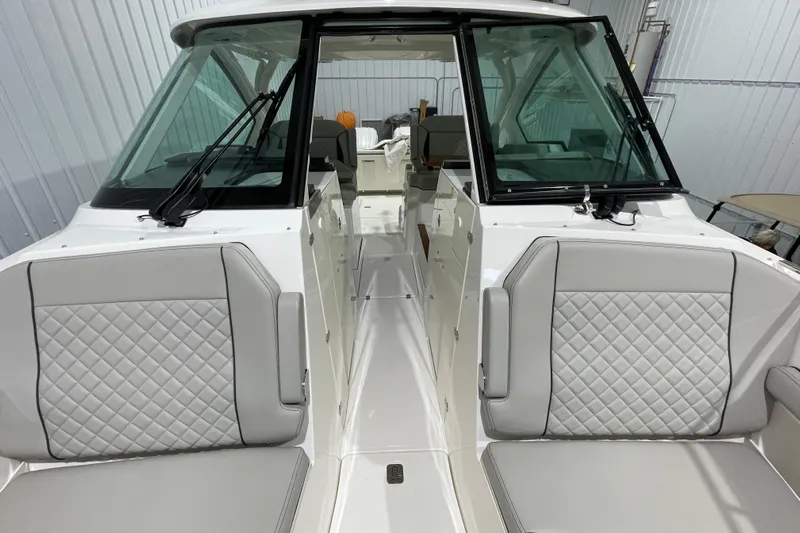  Yacht Photos Pics 2024 Pursuit DC 326 Dual Console boat interior with quilted seating and windshield.