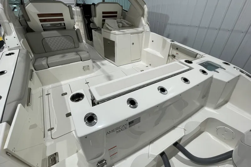  Yacht Photos Pics 2024 Pursuit DC 326 Dual Console boat interior with seating and storage features.