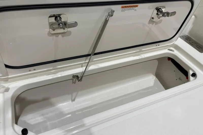  Yacht Photos Pics 2024 Pursuit DC 326 Dual Console storage compartment with secure latches and hydraulic support.
