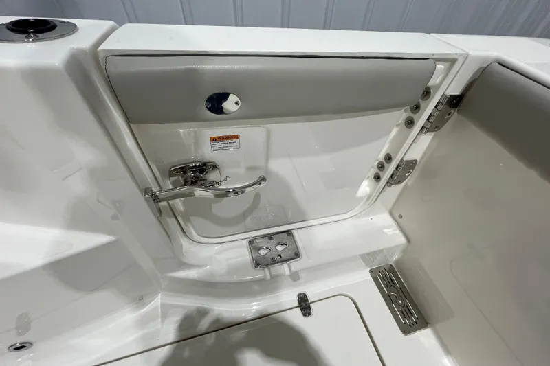  Yacht Photos Pics 2024 Pursuit DC 326 Dual Console boat interior with stainless steel fixtures and storage compartment.