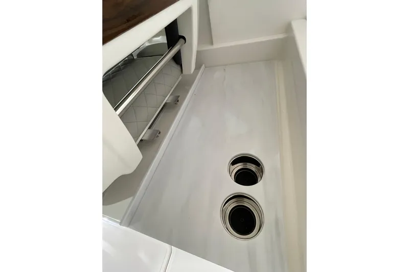  Yacht Photos Pics 2024 Pursuit DC 326 Dual Console interior detail with storage and cup holders.
