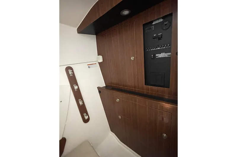  Yacht Photos Pics 2024 Pursuit DC 326 Dual Console interior with wood paneling and control panel.