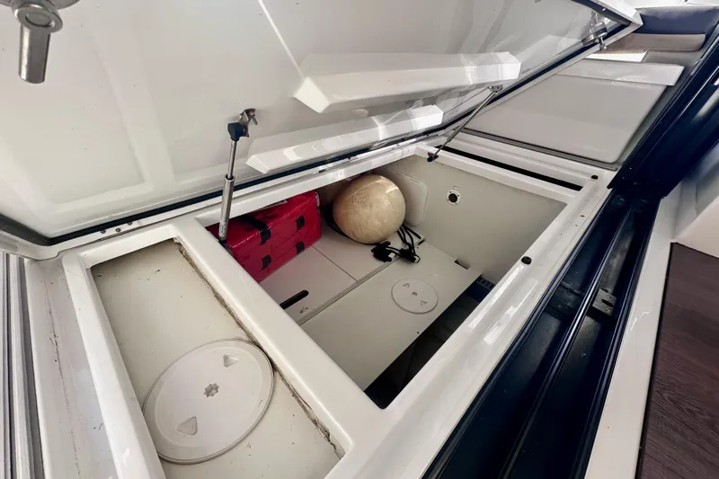  Yacht Photos Pics Open storage compartment in 2021 Beneteau Antares 9 boat, featuring organized interior space.