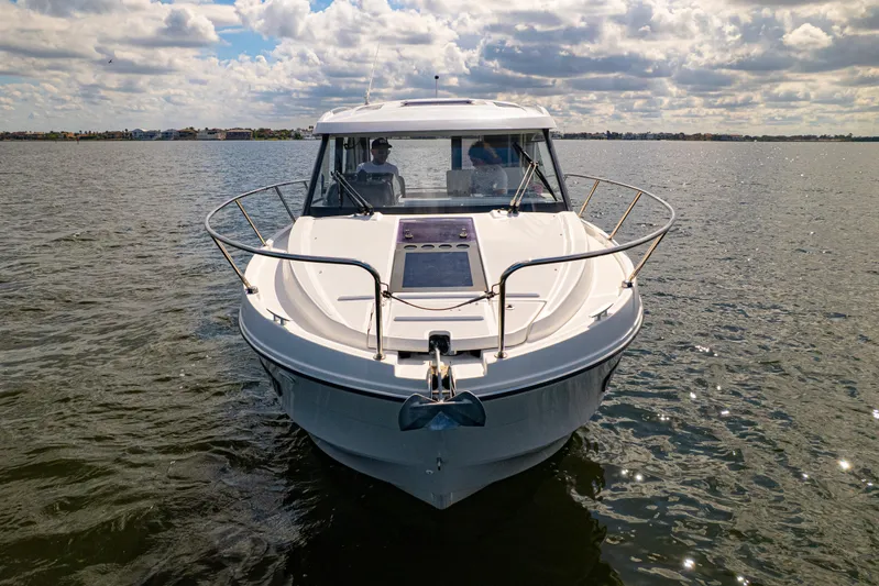  Yacht Photos Pics 2021 Beneteau Antares 9 boat on open water under a cloudy sky.