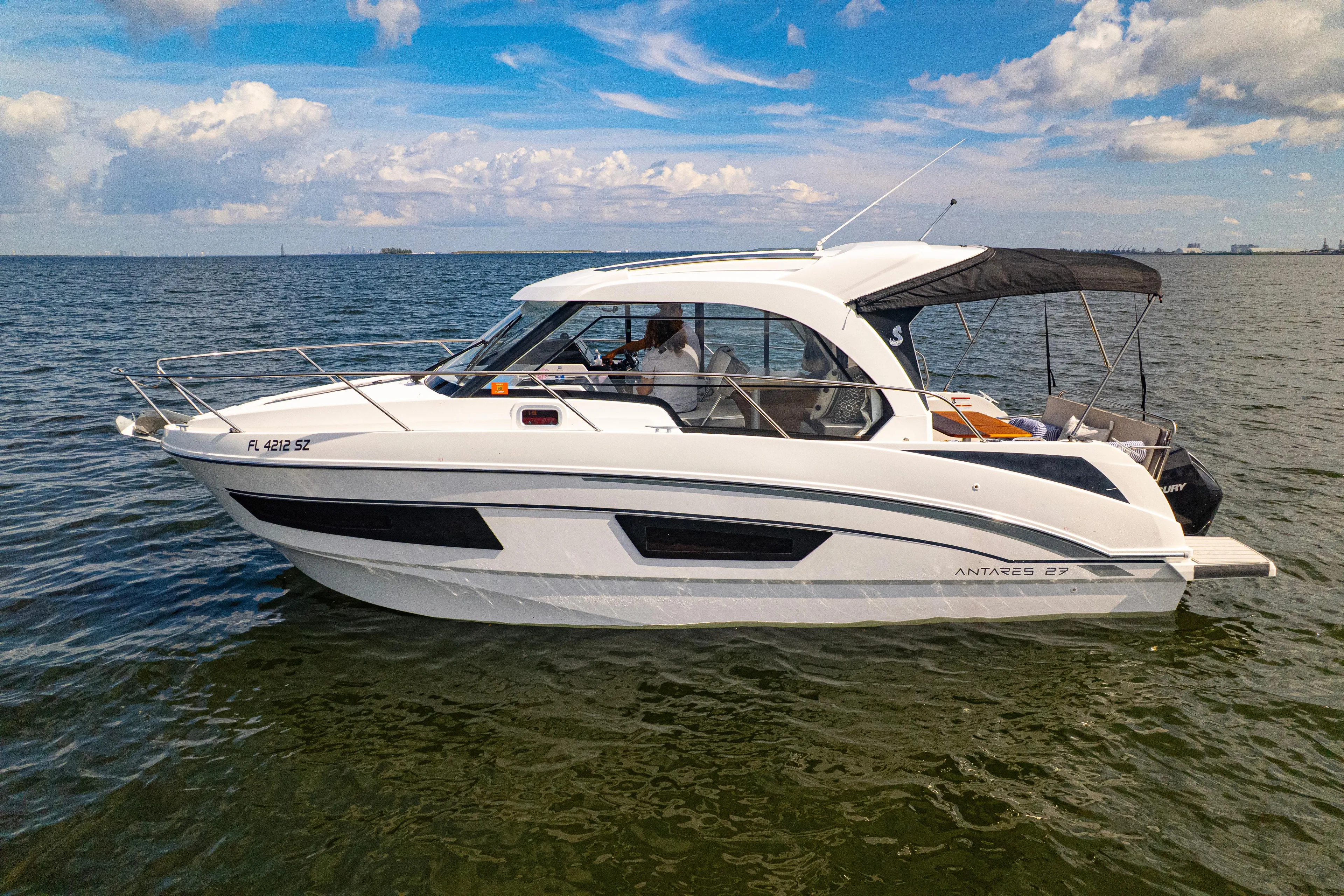  Yacht Photos Pics 2021 Beneteau Antares 9 boat cruising on open water under a blue sky.