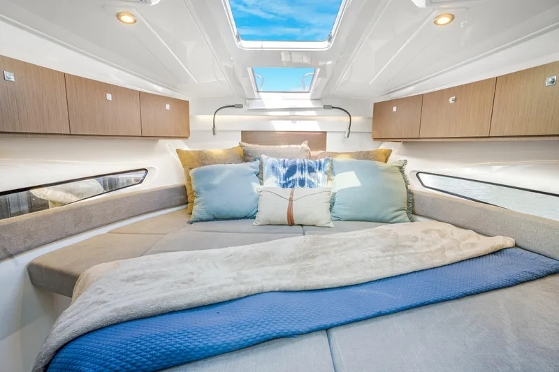  Yacht Photos Pics Luxurious cabin interior of 2021 Beneteau Antares 9 with plush bedding and skylight.