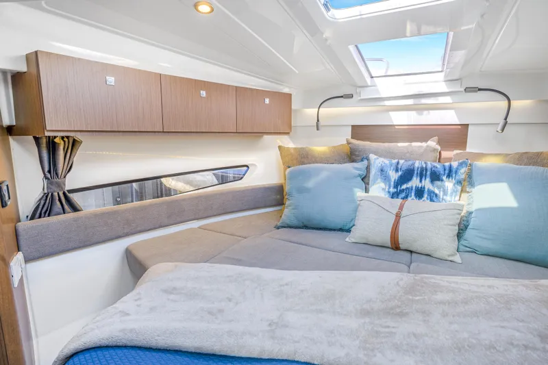  Yacht Photos Pics Luxurious interior of 2021 Beneteau Antares 9 boat with cozy bedding and modern design.