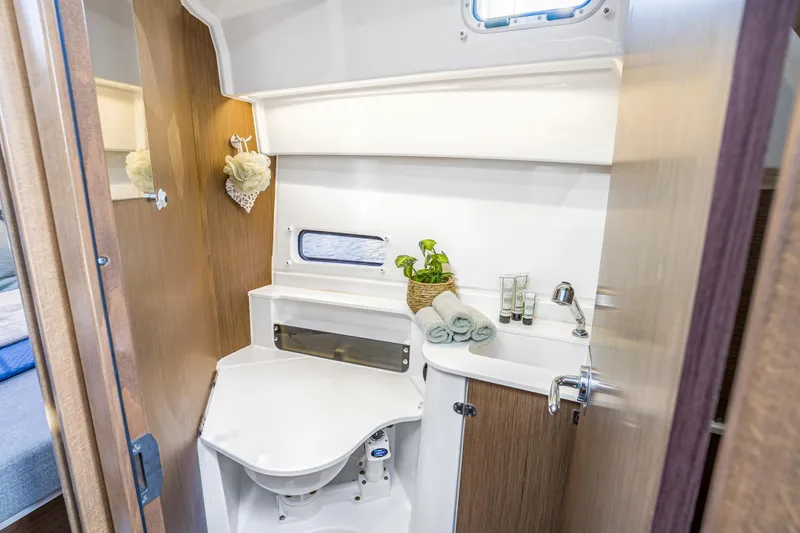  Yacht Photos Pics Modern bathroom interior of 2021 Beneteau Antares 9 boat, featuring sleek design and amenities.