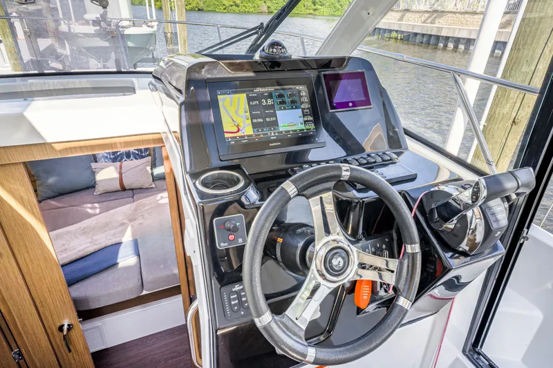  Yacht Photos Pics 2021 Beneteau Antares 9 helm with modern navigation system and comfortable interior cabin.