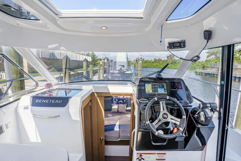  Yacht Photos Pics Interior view of 2021 Beneteau Antares 9 boat cockpit with steering wheel and navigation system.