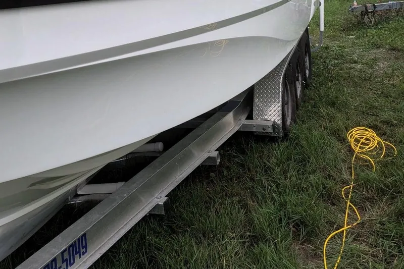  Yacht Photos Pics 2021 Beneteau Antares 9 on trailer with yellow cable on grass.