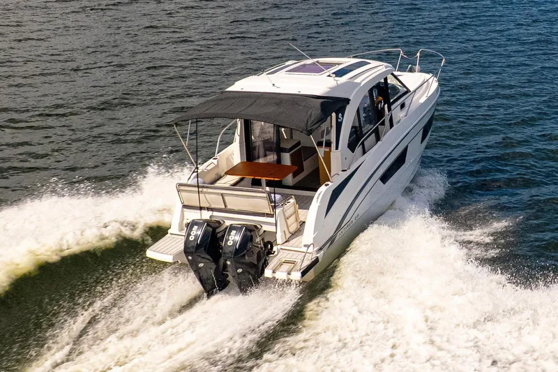  Yacht Photos Pics 2021 Beneteau Antares 9 cruising on open water, showcasing dual outboard engines.