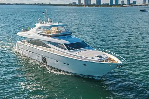 Noral Yacht Photos Pics Luxurious 2011 Ferretti Yachts 830 cruising on open water, city skyline in background.