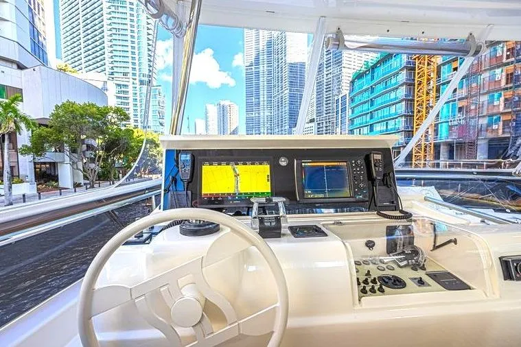 Noral Yacht Photos Pics Cockpit view of 2011 Ferretti Yachts 830, featuring modern navigation equipment and urban skyline.
